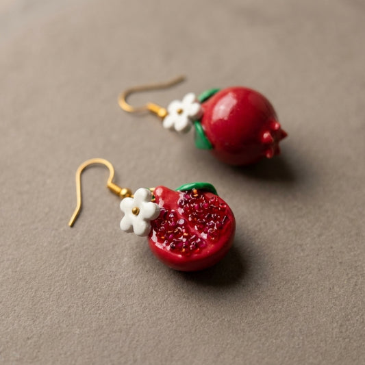 Pomegranates handmade polymer-clay earrings, close-up detail of one earring