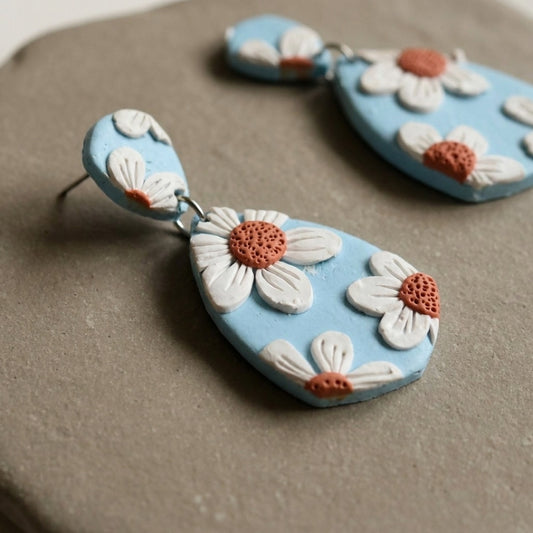 Daisy Blue handmade polymer-clay earrings, close-up detail of one earring