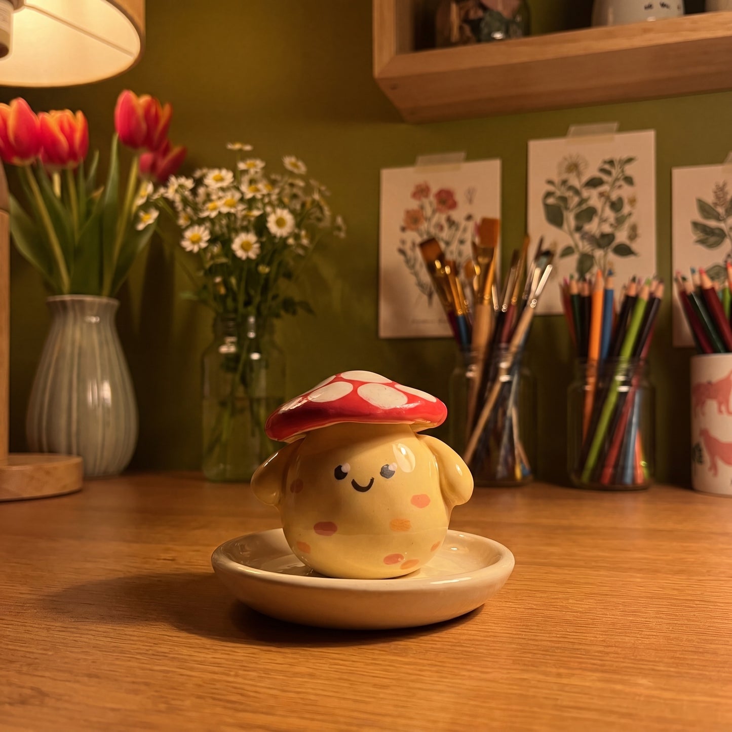 Mushroom Pal handmade glossy clay desk pal, in the Moon Kiln studio, evening lamp light