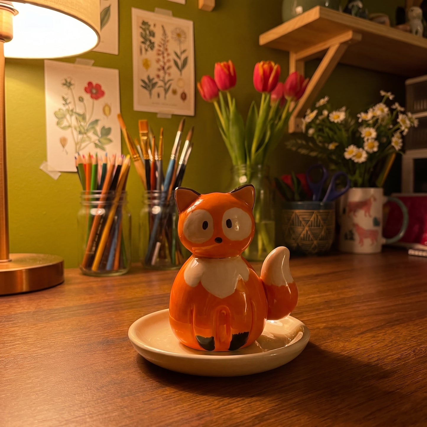 Mr. Fox handmade glossy clay desk pal, in the Moon Kiln studio, evening lamp light