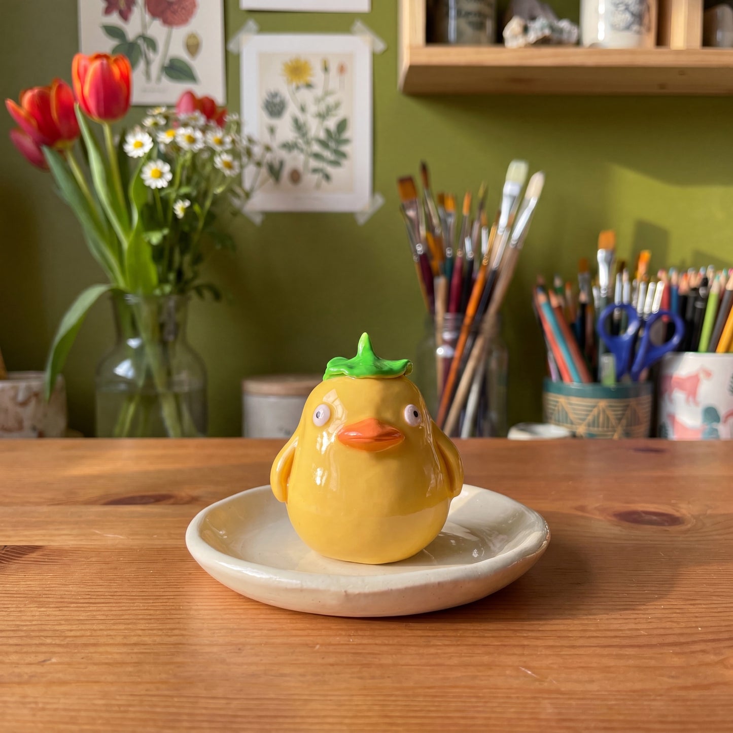 Spirited Ducky handmade glossy clay desk pal, styled in the Moon Kiln studio, daytime