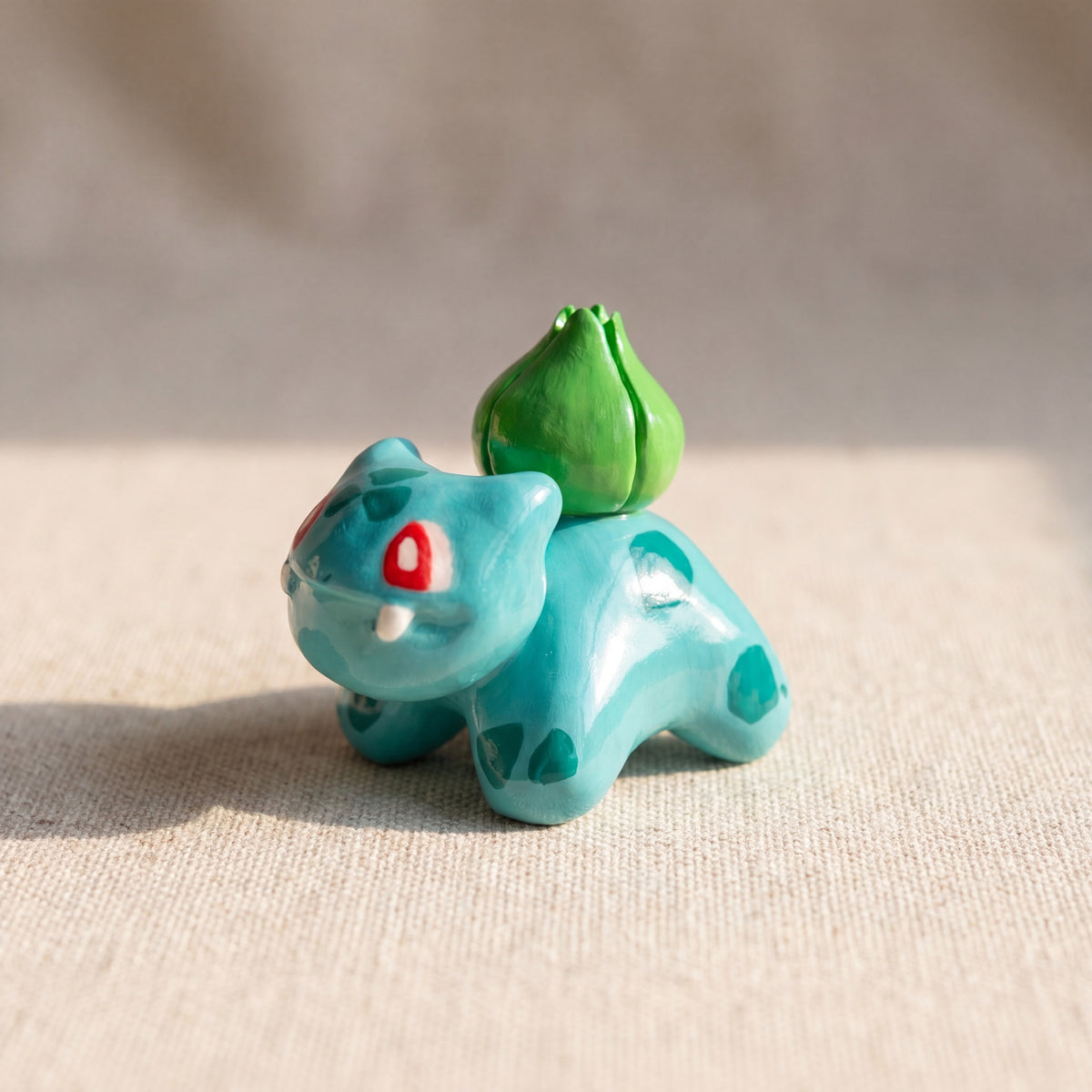 Seed Dinosaur handmade glossy clay desk pal, front view