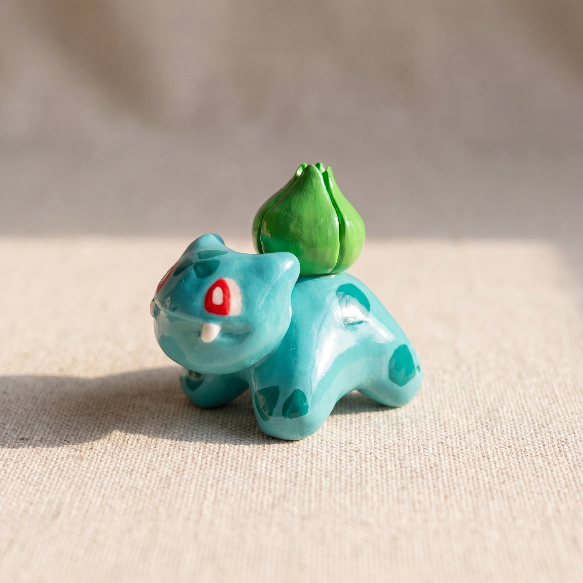 Seed Dinosaur handmade glossy clay desk pal, front view