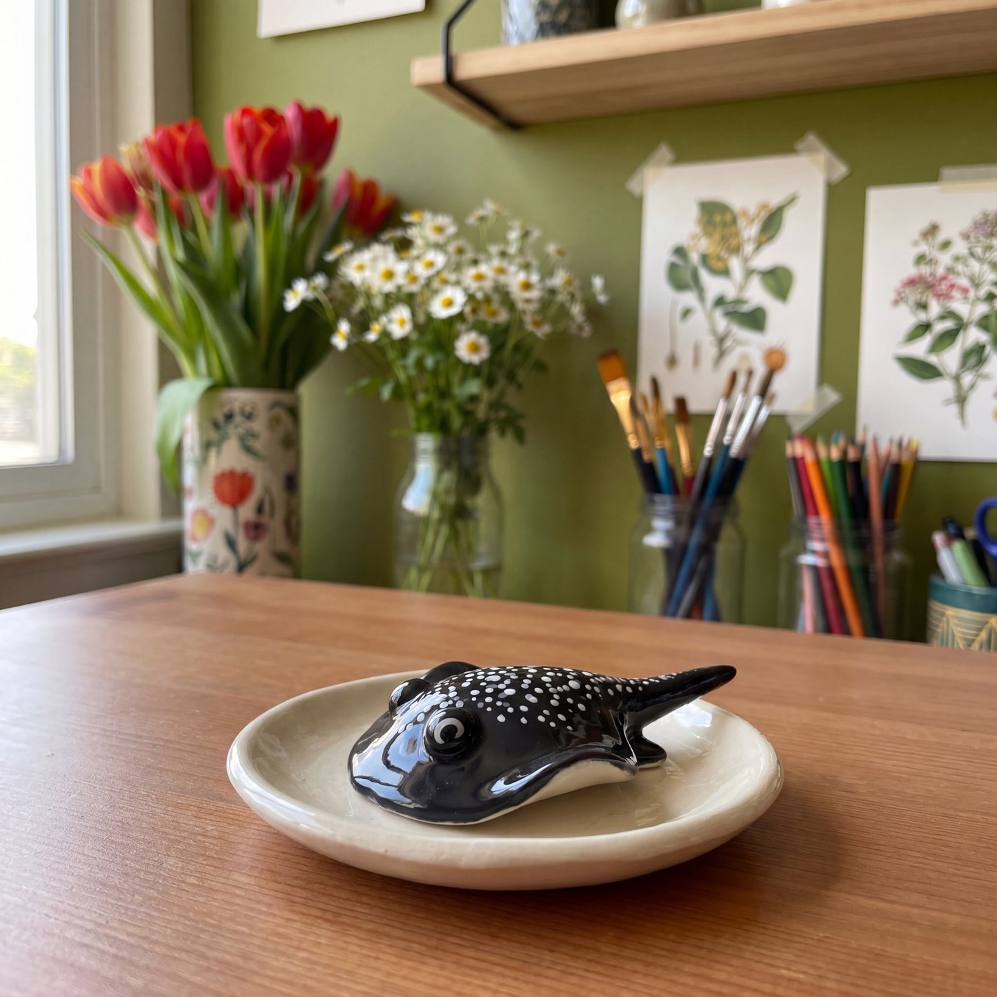 Stinger Ray handmade glossy clay desk pal, styled in the Moon Kiln studio, daytime