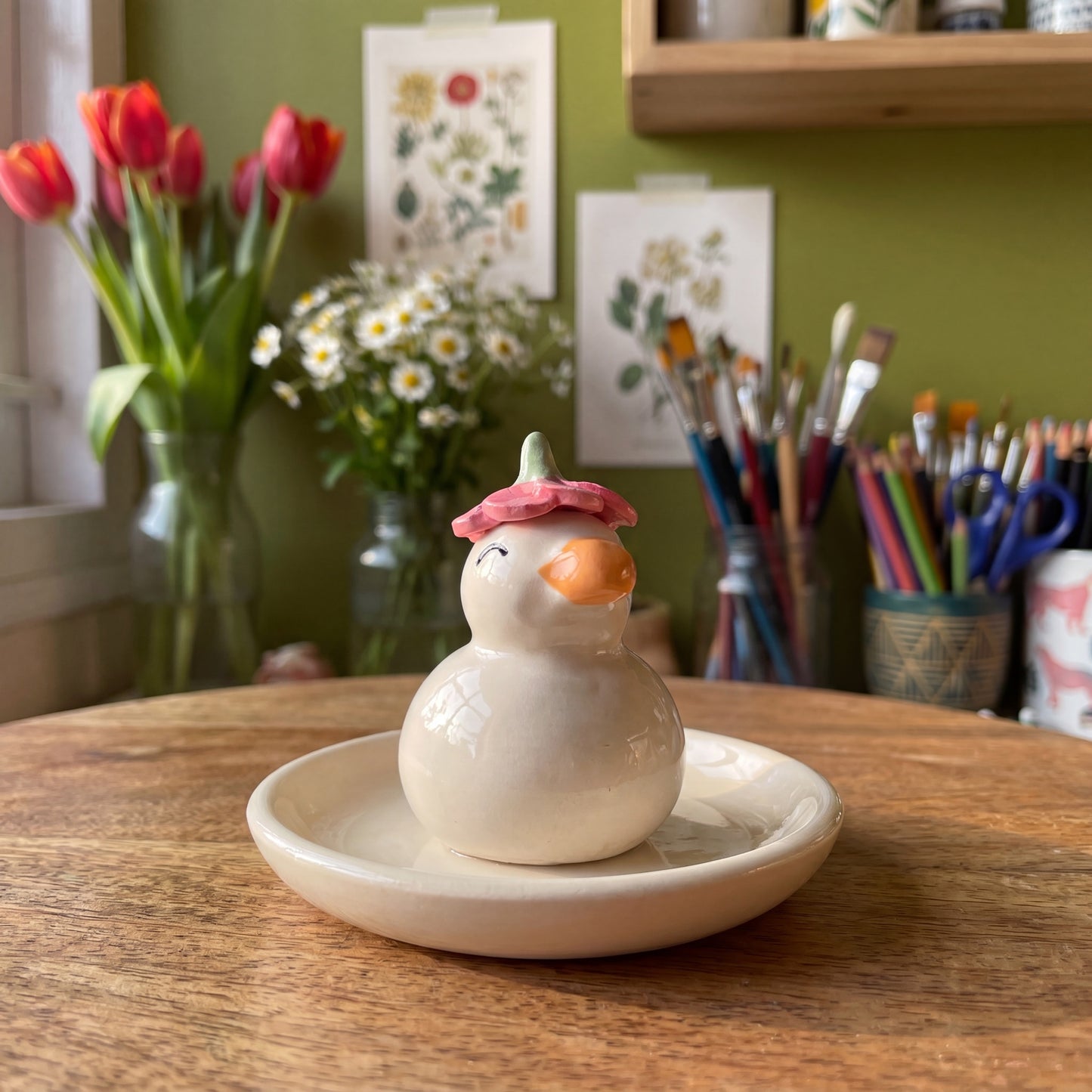 Dreamy Duck handmade glossy clay desk pal, styled in the Moon Kiln studio, daytime