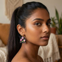 Magnolia handmade polymer-clay earrings, worn on the ear