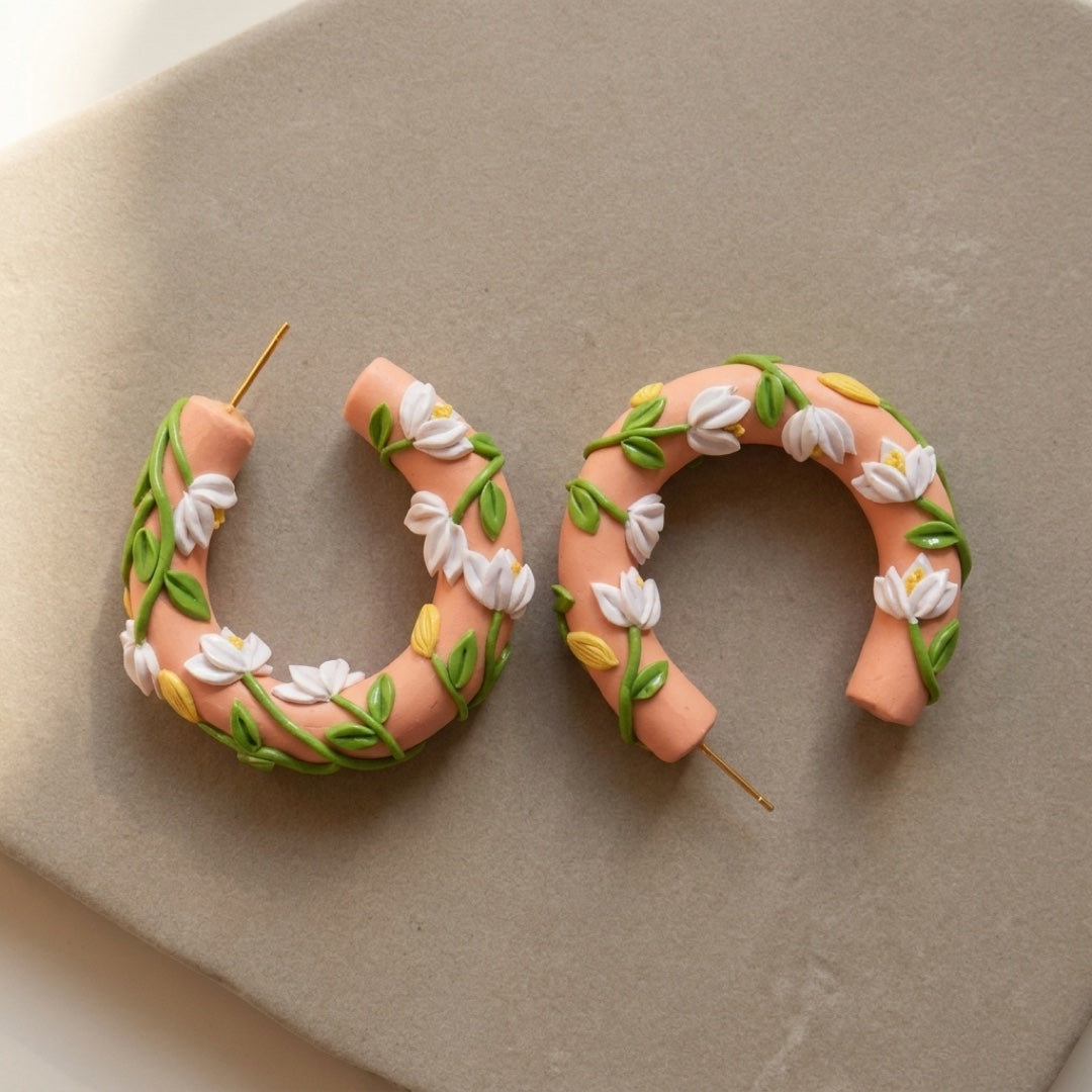 Sunset Hoops handmade polymer-clay earrings, the pair on a warm stone surface