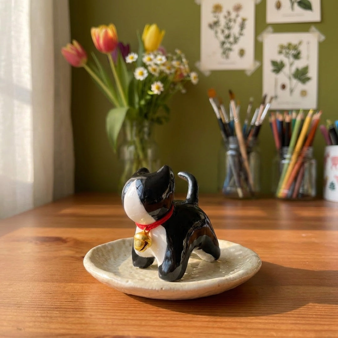 Tuxedo kitty handmade glossy clay desk pal, styled in the Moon Kiln studio, daytime