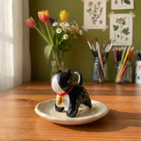 Tuxedo kitty handmade glossy clay desk pal, styled in the Moon Kiln studio, daytime