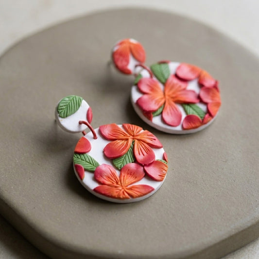 Frangipani handmade polymer-clay earrings, close-up detail of one earring