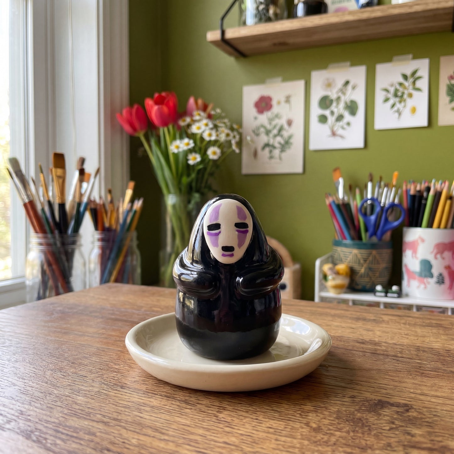 Masked Spirit handmade glossy clay desk pal, styled in the Moon Kiln studio, daytime