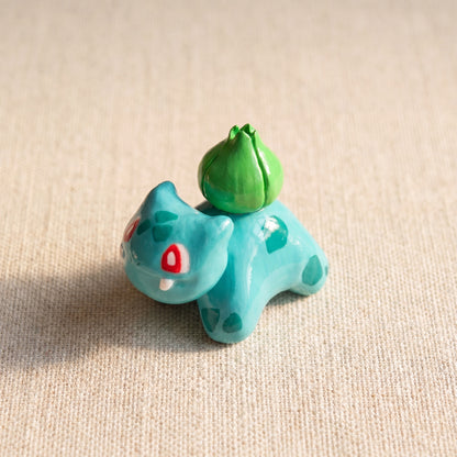 Seed Dinosaur handmade glossy clay desk pal, isometric view
