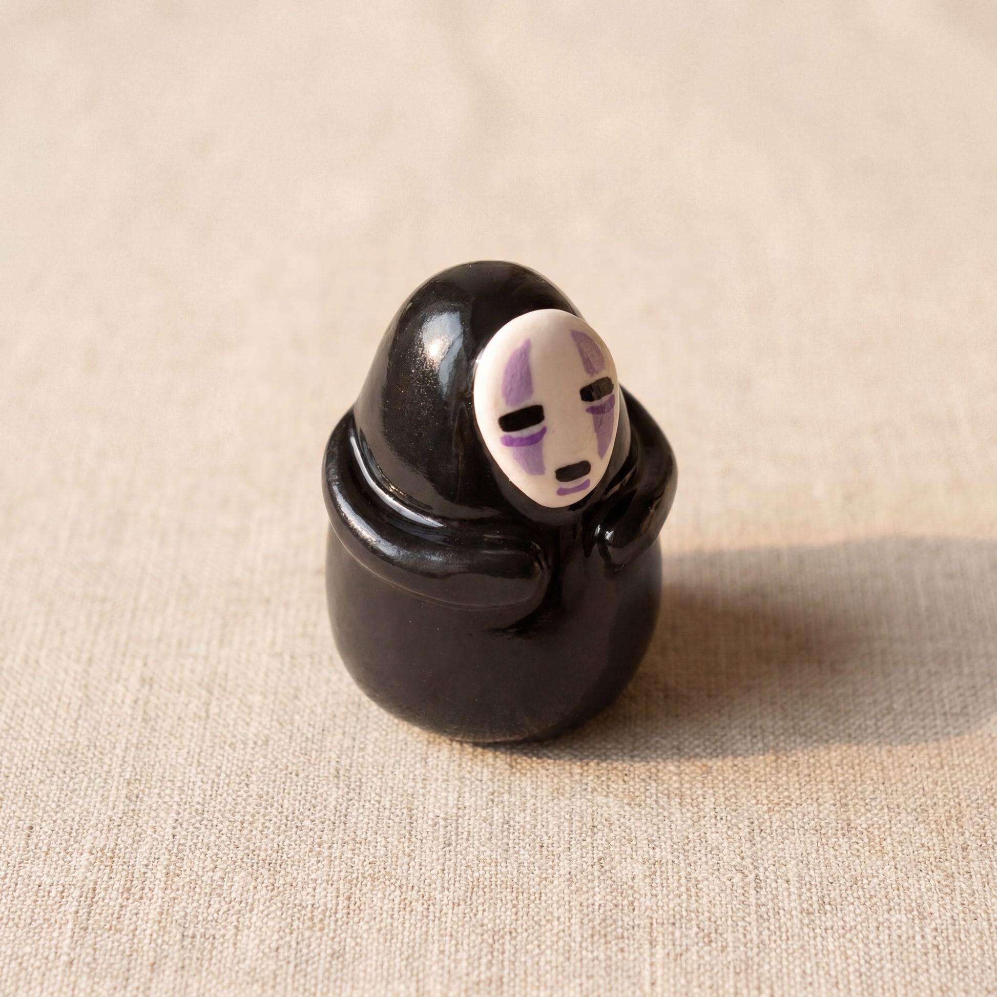 Masked Spirit handmade glossy clay desk pal, isometric view