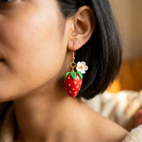 Strawberries handmade polymer-clay earrings, worn on the ear