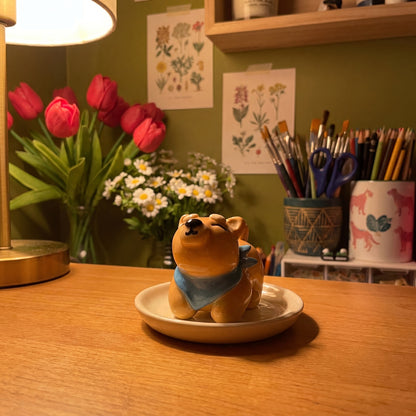 Shiba Inu handmade glossy clay desk pal, in the Moon Kiln studio, evening lamp light
