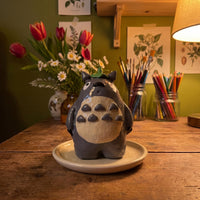 Forest Spirit (Large) handmade glossy clay desk pal, in the Moon Kiln studio, evening lamp light