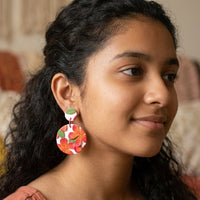 Frangipani handmade polymer-clay earrings, worn on the ear
