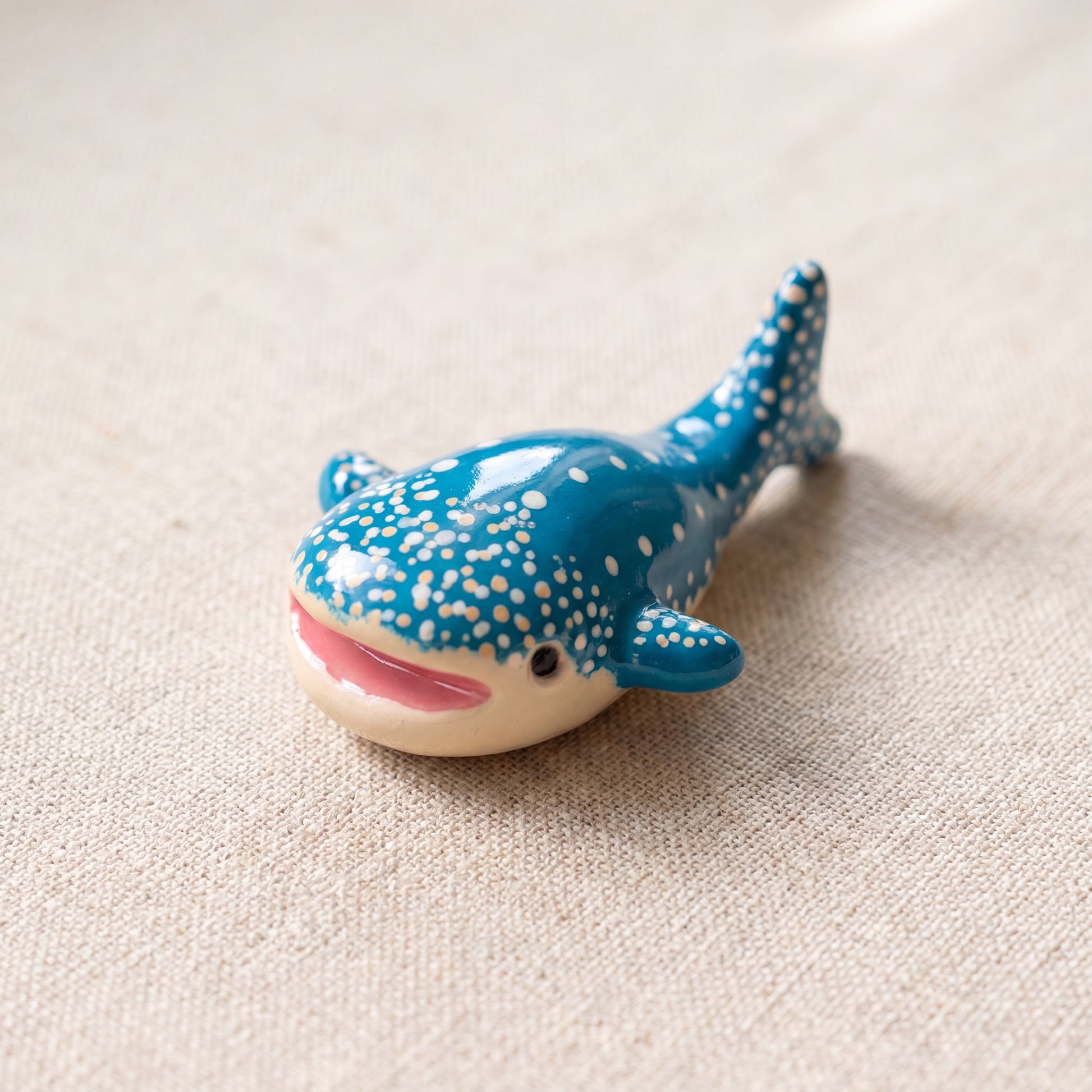 Happy Whale handmade glossy clay desk pal, isometric view