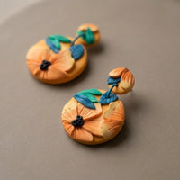 Tropical Daylily handmade polymer-clay earrings, close-up detail of one earring