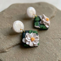 White Lotus handmade polymer-clay earrings, close-up detail of one earring