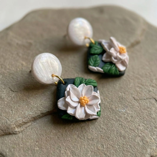 White Lotus handmade polymer-clay earrings, close-up detail of one earring