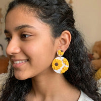 Sunflower Dangles handmade polymer-clay earrings, worn on the ear