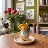 Sunny Bunny handmade glossy clay desk pal, styled in the Moon Kiln studio, daytime