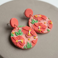 Hibiscus handmade polymer-clay earrings, close-up detail of one earring