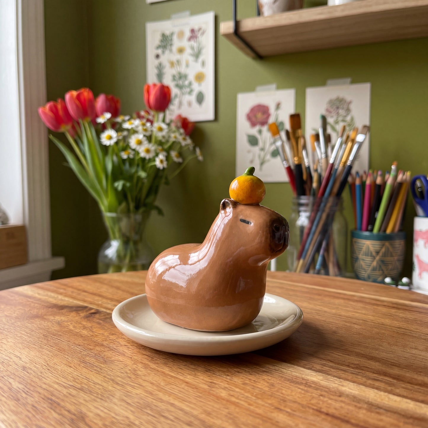Capybara handmade glossy clay desk pal, styled in the Moon Kiln studio, daytime