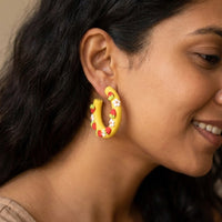 Strawberry Hoops handmade polymer-clay earrings, worn on the ear