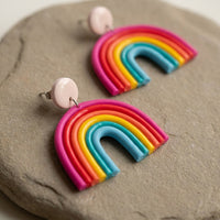 Rainbow handmade polymer-clay earrings, close-up detail of one earring