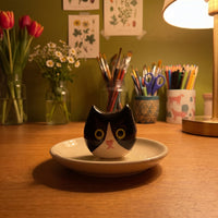 Charlie handmade glossy clay desk pal, in the Moon Kiln studio, evening lamp light