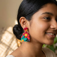 Chroma Flora handmade polymer-clay earrings, worn on the ear
