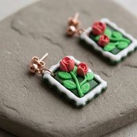 Roses Stamp handmade polymer-clay earrings, close-up detail of one earring