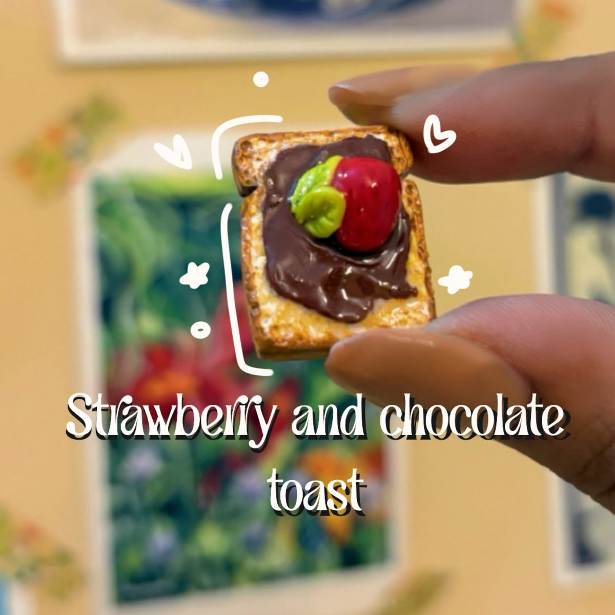 Strawberry and chocolate toast handmade polymer clay keychain, miniature toast with chocolate spread and red strawberry, held in fingers