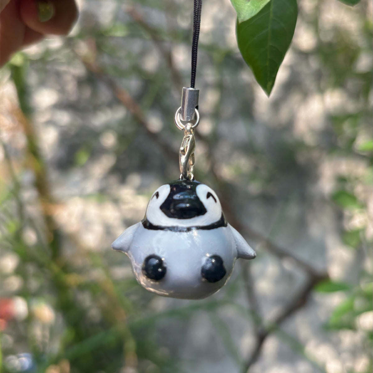 Baby Penguin handmade polymer clay charm, glossy round grey and black penguin chick with white belly, on black cord clasp