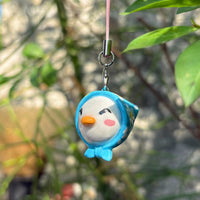 Blue Hooded Bird handmade polymer clay charm, round white bird face with blue hoodie, orange beak, and rosy cheeks, on silver cord