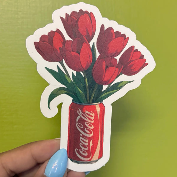 Tulip cola vinyl sticker, illustrated red tulip bouquet in a cola can, die-cut shape with white border, held in hand