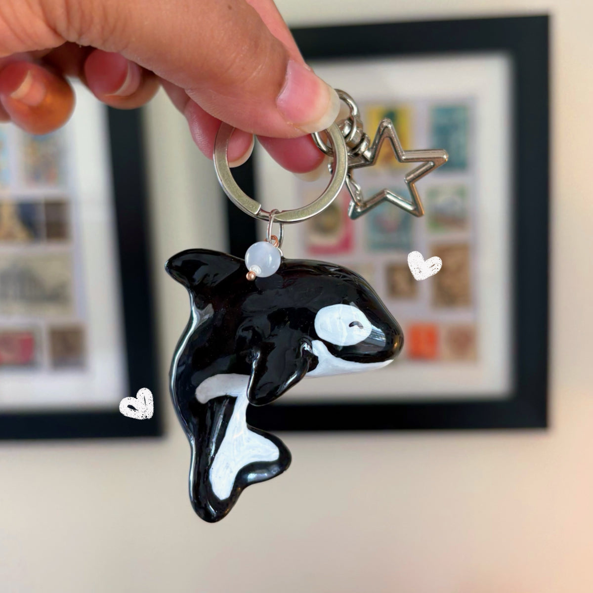 Orca handmade polymer clay keychain, glossy black and white killer whale with white eye patch, on silver ring with star clasp