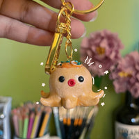 Takoyaki handmade polymer clay keychain, cute octopus ball character with toppings and red nose, glossy finish on gold ring