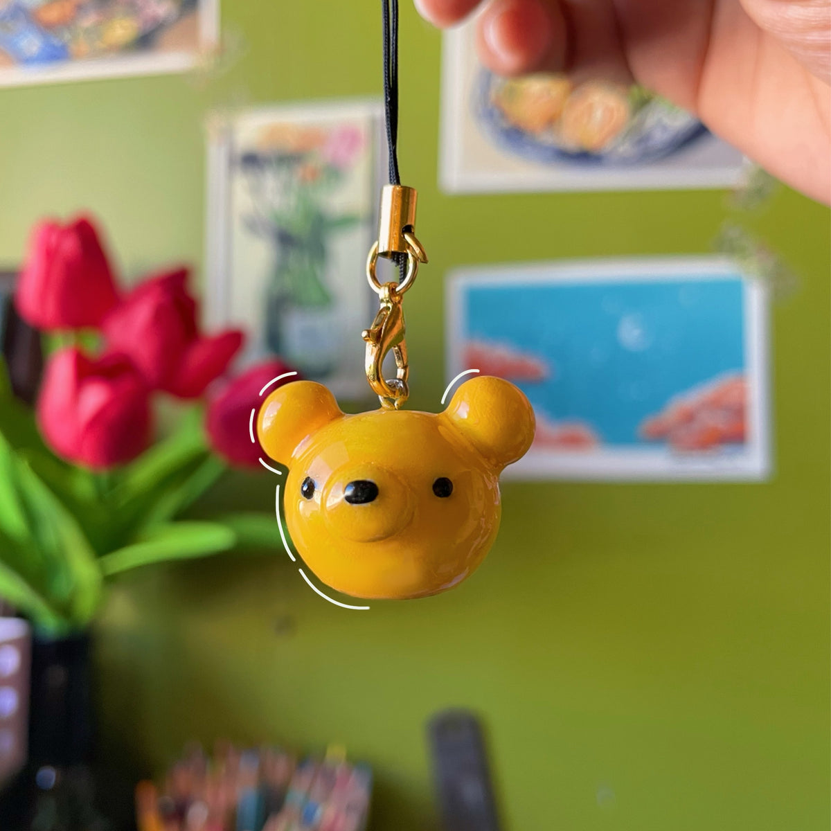 Candy Bear handmade polymer clay charm, glossy golden bear head with round ears on gold clasp, suspended from black cord