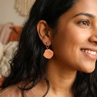 Cordelia’s Blush handmade polymer-clay earrings, worn on the ear