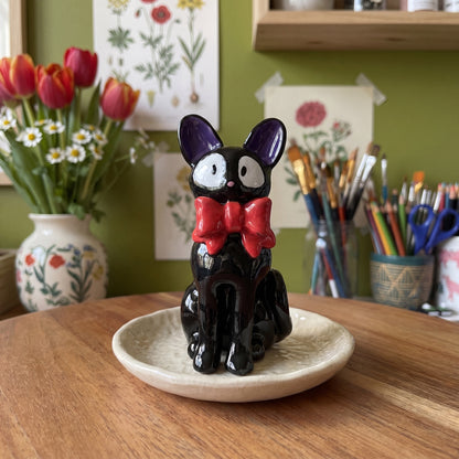 Midnight Cat clay figurine styled in the Moon Kiln studio, daytime