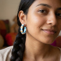 Daisy Blue Hoops handmade polymer-clay earrings, worn on the ear