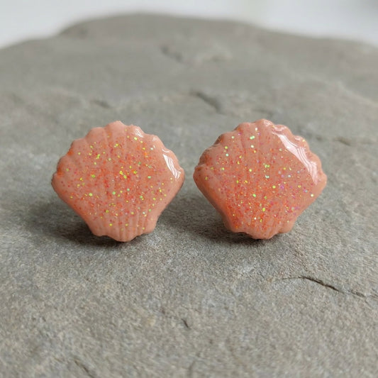Seashell Studs handmade polymer-clay earrings, the pair on a warm stone surface