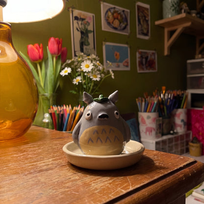 Forest Spirit handmade glossy clay desk pal, in the Moon Kiln studio, evening lamp light