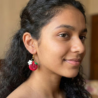 Pomegranates handmade polymer-clay earrings, worn on the ear