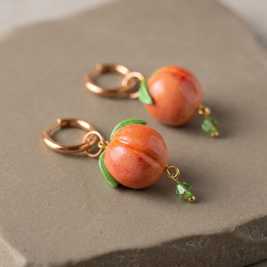 Peaches handmade polymer-clay earrings, close-up detail of one earring