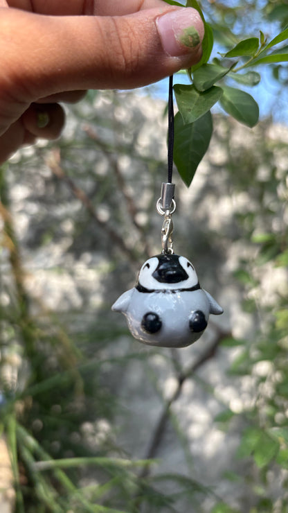 Baby Penguin handmade polymer clay charm, in-hand scale showing small round penguin chick charm with glossy finish