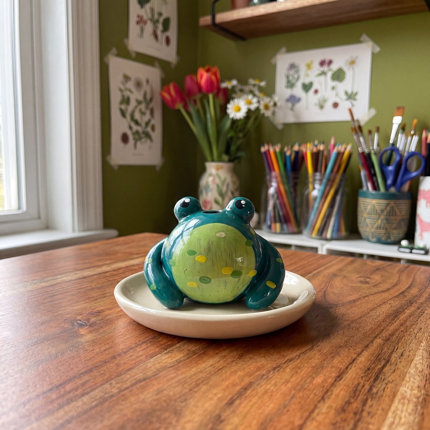 Mr. Ribbit handmade glossy clay desk pal, styled in the Moon Kiln studio, daytime